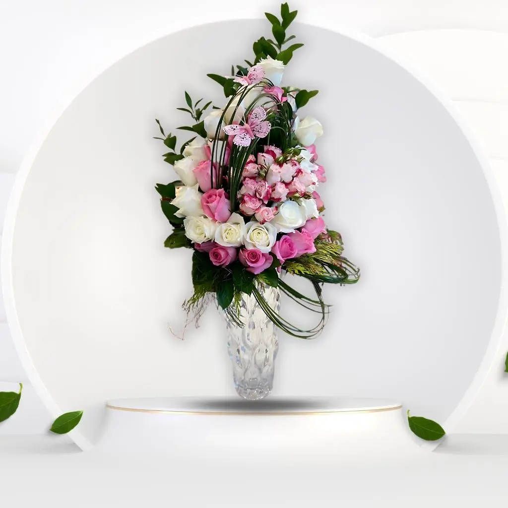 A Glass Vase With Natural Pink And White Roses